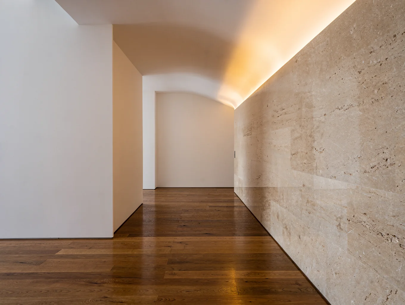 Architectural interior representing lived spatial conditions with indirect night lighting and soft thresholds